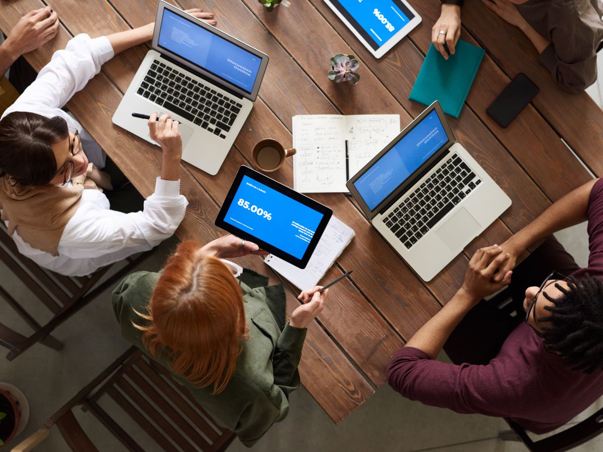 Team analyzing marketing performance data and campaign results on laptops